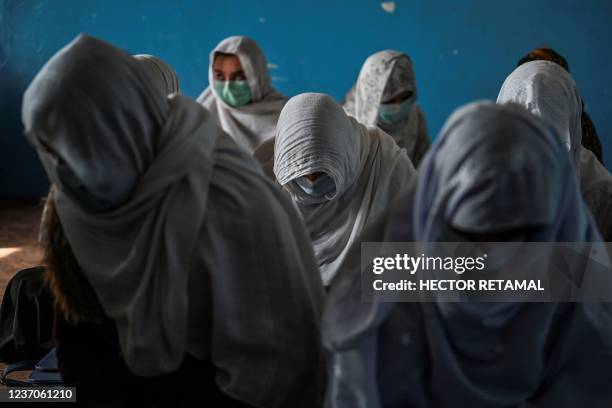 This picture taken on November 16, 2021 shows women sitting inside their classroom at Noorania school, in Sharan city, in the Paktika province. -...