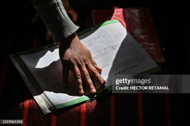 This picture taken on November 14, 2021 shows a female student sitting inside a classroom of grade 12 at a school in Langar village, in the Qarabagh...