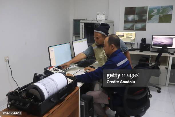 Officers observe volcanic activity using a seismograph at Gunung Sawur monitoring post in Lumajang Regency, Indonesia on December 6, 2021.