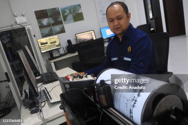 An officer observes volcanic activity using a seismograph at Gunung Sawur monitoring post in Lumajang Regency, Indonesia on December 6, 2021.