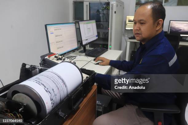 An officer observes volcanic activity using a seismograph at Gunung Sawur monitoring post in Lumajang Regency, Indonesia on December 6, 2021.