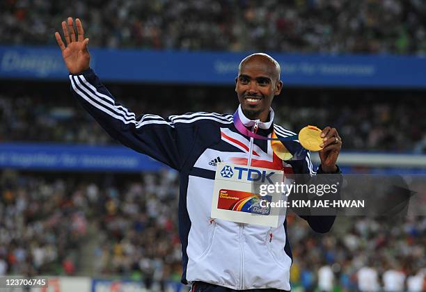 Gold medallist Britain's Mohammed Farah poses during the award ceremony for the men's 5,000 metres event at the International Association of...