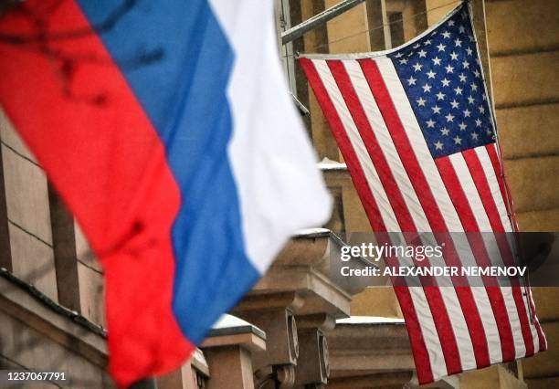 Russian flag flies next to the US embassy building in Moscow on December 7, 2021. - Russian President Vladimir Putin and US President Joe Biden will...