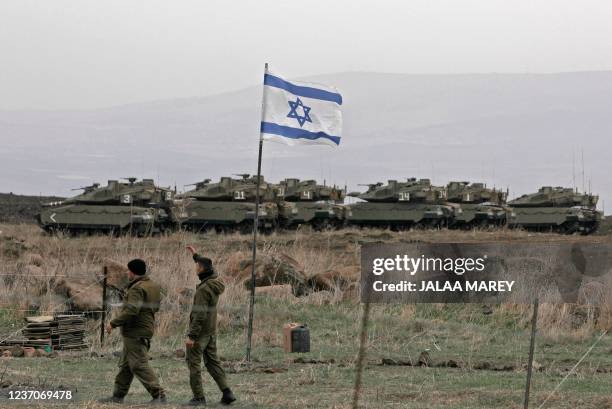 Israeli tanks are seen in action during a military drill near Ramat Trump settlement in the Israel-annexed Golan Heights on December 7, 2021. - An...