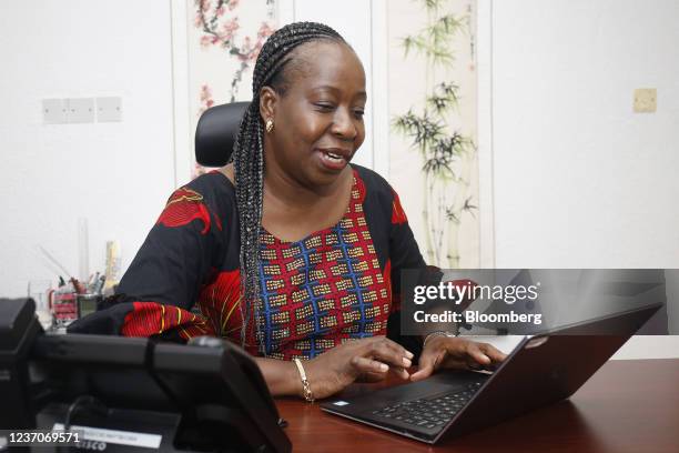 Funke Opeke, founder and chief executive officer of MainOne, works on a laptop computer following an interview in Lagos, Nigeria, on Tuesday, Feb....