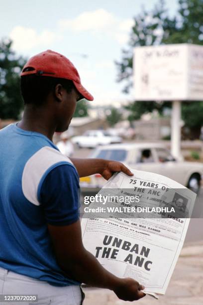 Reader holds a copy of the liberal weekly newspaper, the Weekly Mail, which has an advertisement of the African National Congress 75th anniversary,...