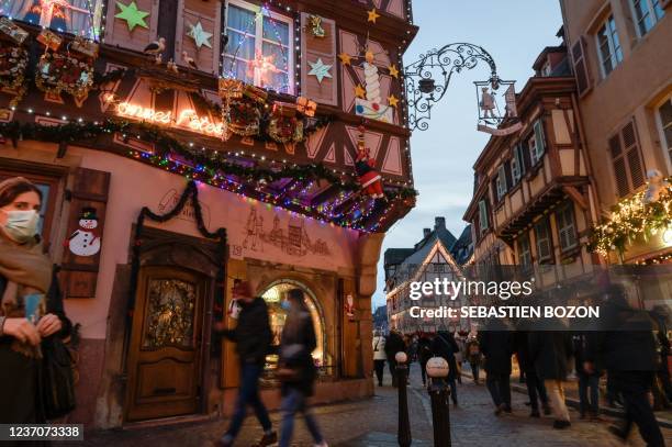 Visitors walk in the streets of the Christmas market in Colmar, eastern France, on December 7, 2021.