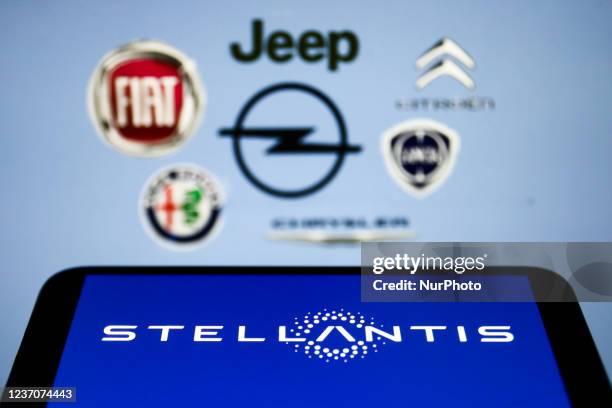 Stellantis logo displayed on a phone screen is seen with some of the company brands logos displayed in the background in this illustration photo...