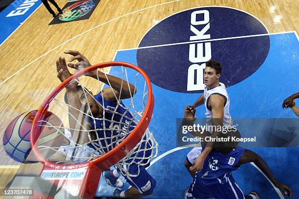 Nicolas Batum of France throws the ball and Florent Pietrus of France fights for the ball during the EuroBasket 2011 first round group B match...