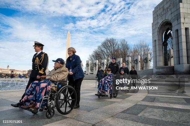 Veterans are escorted to the Freedom Wall for a wreath laying ceremony during an event commemorating the 80th anniversary of the attack on Pearl...