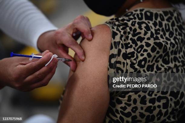 Nurse applies a dose of the AstraZeneca vaccine against COVID-19 during the first day of the application of the third dose to people over 60...