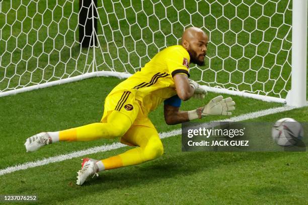 Algeria's goalkeeper Rais M'Bolhi dives for a penalty during the FIFA Arab Cup 2021 group D football match between Algeria and Egypt at the Al-Janoub...