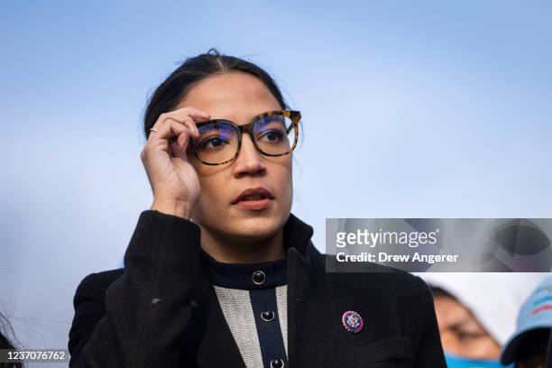 Rep. Alexandria Ocasio-Cortez prepares to speak during a rally for immigration provisions to be included in the Build Back Better Act outside the...