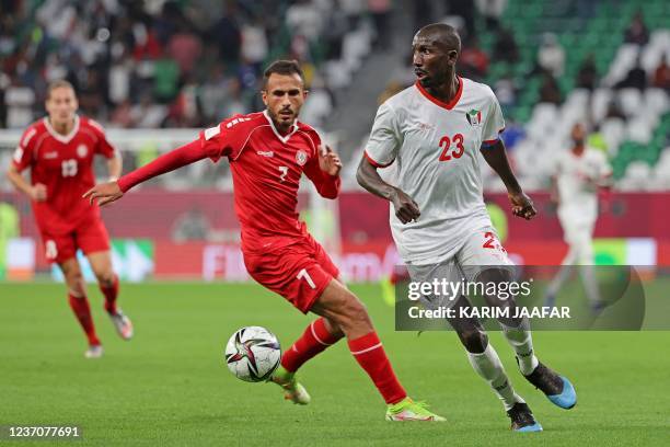 Sudan's midfielder Nasr Eldin el-Shigail is marked by Lebanon's forward Fadel Antar during the FIFA Arab Cup 2021 group D football match between...