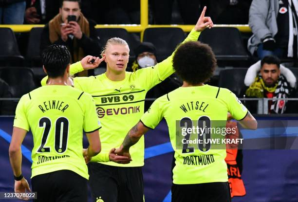 Dortmund's Norwegian forward Erling Haaland celebrates with Dortmund's Brazilian midfielder Reinier and Dortmund's Belgian midfielder Axel Witsel...