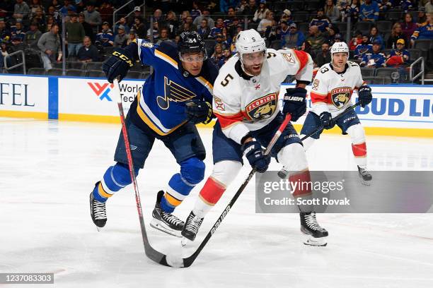 Dakota Joshua of the St. Louis Blues battles with Aaron Ekblad of the Florida Panthers at the Enterprise Center on December 7, 2021 in St. Louis,...