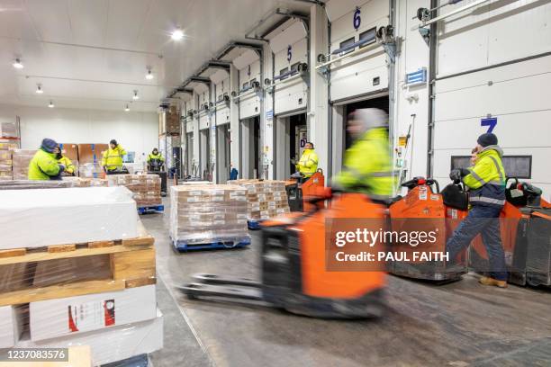 Employees prepare packaged food for distribution across Ireland at the Derry Refrigerated Transport warehouse in Portadown in Armagh on November 29,...