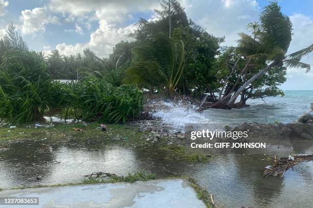 Photo taken on December 6, 2021 shows high-tide flooding in the Marshall Islands capital Majuro. - A swathe of Pacific island nations were cleaning...