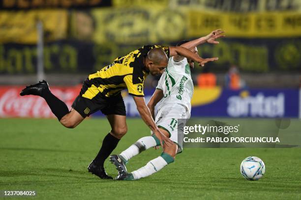 Penarol's Walter Gargano vies for the ball with Plaza Colonia's Nicolas Dibble during their Uruguayan tournament final football match at the...