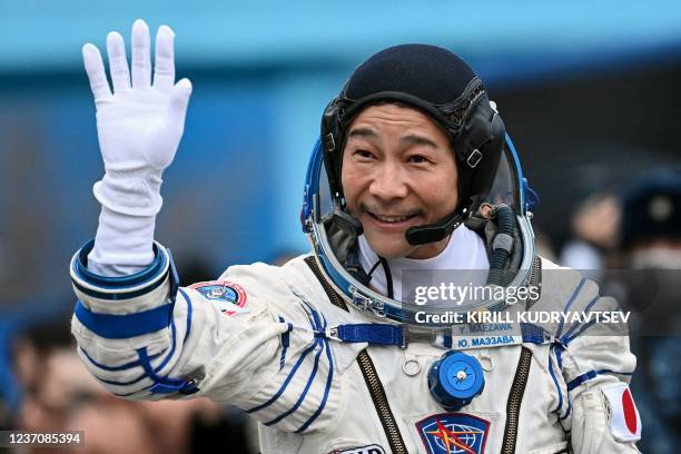 Japanese billionaire Yusaku Maezawa waves before boarding the Soyuz MS-20 spacecraft prior to the launch at the Baikonur cosmodrome on December 8,...