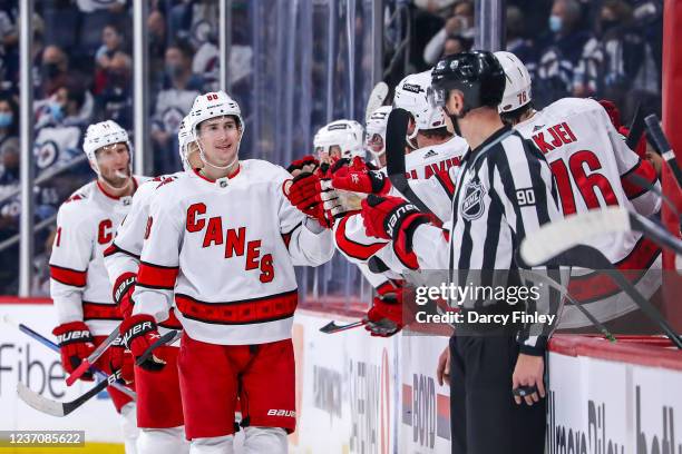 Martin Necas of the Carolina Hurricanes celebrates his second period goal against the Winnipeg Jets with teammates at the bench at the Canada Life...