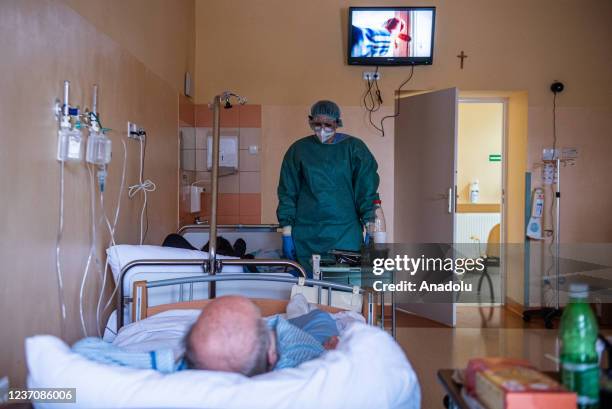 Medical personnel wear personal protective equipment as they assist a COVID -19 unvaccinated patient inside the Emergency Ward converted to a COVID...