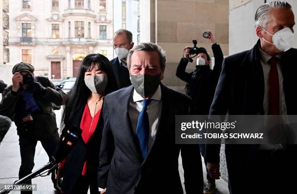 Former German Chancellor Gerhard Schroeder and his wife Schroeder-Kim So-yeon arrive to attend a session at the Bundestag in Berlin on December 8,...