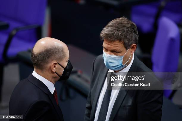 Olaf Scholz of the German Social Democrats , designated Chancellor, speaks with Robert Habeck , co-leader of the German Greens Party, designated...