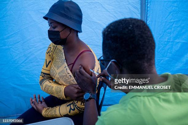 Patient gets vaccinated against COVID-19 by the Witkoppen clinic at the Kya Sands informal settlement Johannesburg on December 8, 2021. - Anti-Covid...