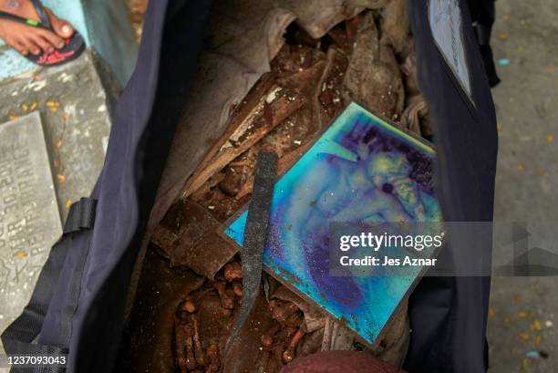 The remains and a picture of Rodolfo Alejandro, who was killed by state forces during the bloody drug war, are transferred into a body bag as Family...