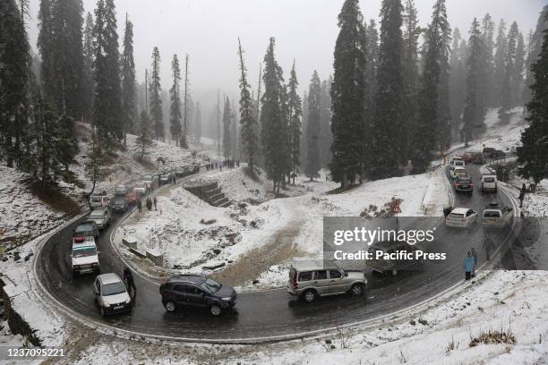 Vehicles move on snow covered hilly area as it snows in Kashmir. Indian Meteorological Department has predicted moderate snowfall across Kashmir and...