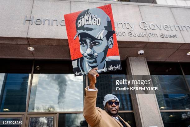 Philonise Floyd, George Floyd's brother, holds a Daunte Wright image outside the Hennepin County Government Center as the trial of former Brooklyn...