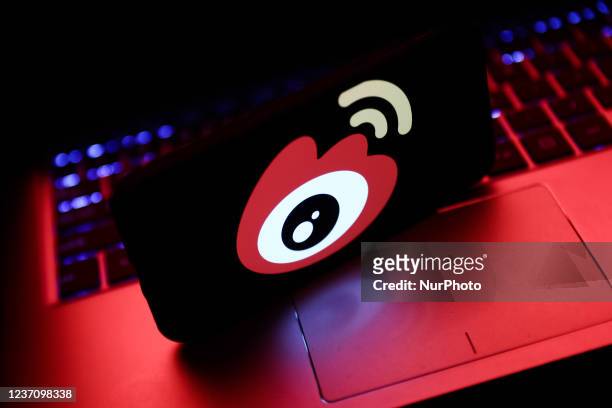 Weibo logo displayed on a phone screen and a laptop keyboard are seen in this illustration photo taken in Krakow, Poland on December 8, 2021.