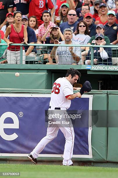 Conor Jackson of the Boston Red Sox runs into the wall chasing a hit by Ian Kinsler of the Texas Rangers on September 4, 2011 at Fenway Park in...