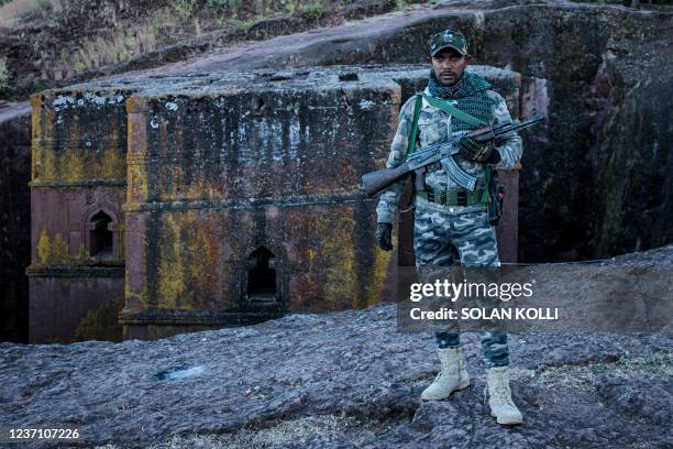 An Amhara Fano militia fighter poses at Saint George Church in Lalibela, on December 7, 2021. - Residents of Lalibela, a city in northern Ethiopia...