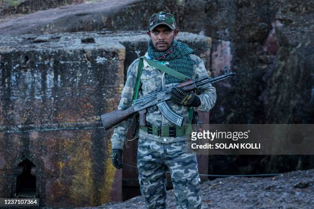 Amhara Fano militia fighter Eshete Zewudru poses at Saint George Church in Lalibela, on December 7, 2021. - Residents of Lalibela, a city in northern...