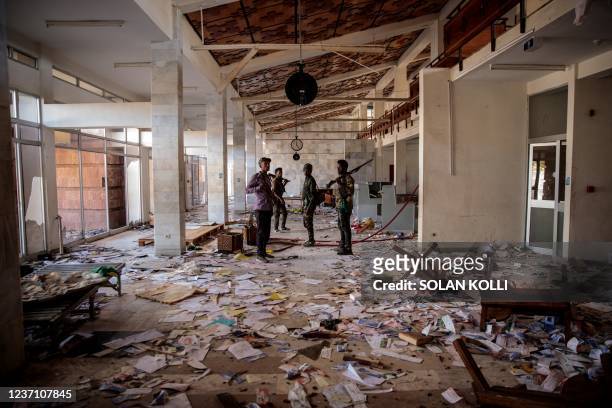 Amhara Fano militia fighters walk in the ransacked terminal at the Lalibela airport in Lalibela, o++n December 7, 2021. - Residents of Lalibela, a...