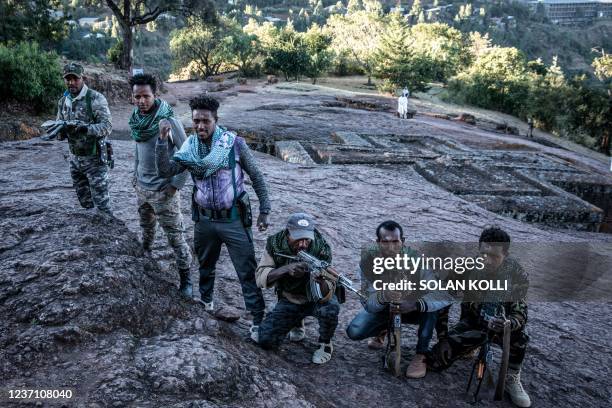 Amhara Fano militia fighters pose at Saint George Church in Lalibela, on December 7, 2021. - Residents of Lalibela, a city in northern Ethiopia home...