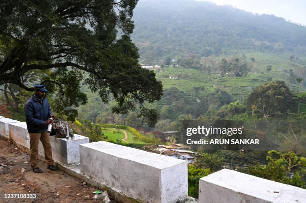 Policeman guards a roadblock to the site a day after an army helicopter crashed, killing 13 people, including Indian defence chief General Bipin...