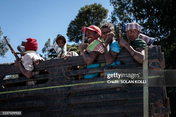 Amhara militia fighters ride on a truck in Nifas Mewcha, Ethiopia, on December 6, 2021. - Residents of Lalibela, a city in northern Ethiopia home to...