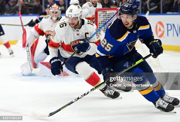 Florida Panthers center Aleksander Barkov and St. Louis Blues center Jordan Kyrou track the puck during a NHL game between the Florida Panthers and...