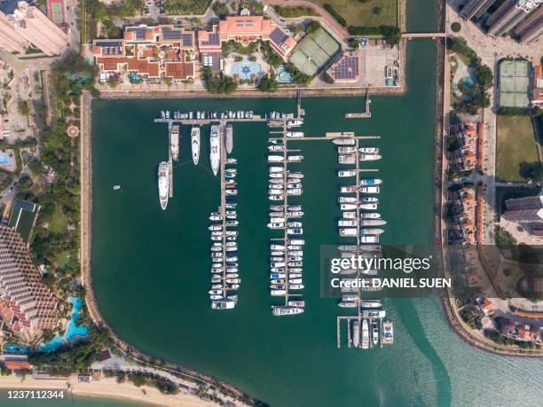 This aerial photo taken on December 9, 2021 shows yachts docked at the Gold Coast Yacht & Country Club alongside residential buildings in Hong Kong.