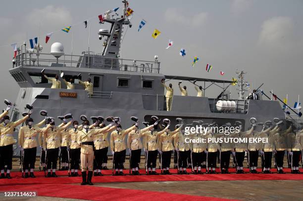Naval ratings, junior enlisted sailors, raise their hats to salute President Mohammadu Buhari during the inauguration of locally built Seaward...