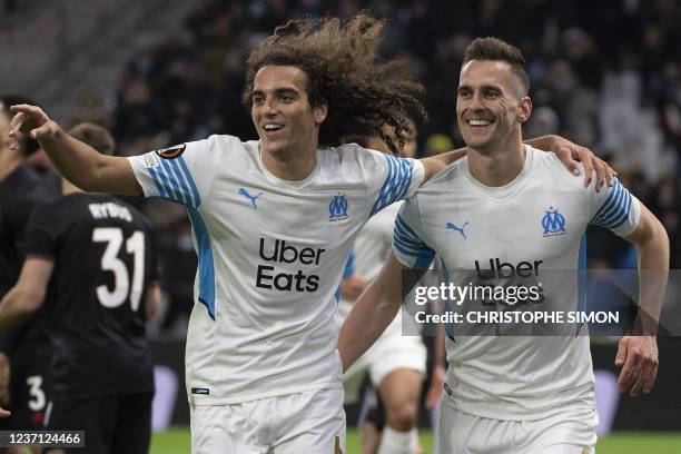 Marseille's Polish forward Arkadiusz Milik celebrates with Marseille's French defender Matteo Guendouzi after scoring his team's first goal during...