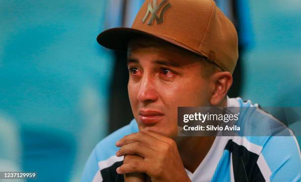 Fan of Gremio cries after his team is relegated from the top-division to Serie B after the match between Gremio and Atletico Mineiro as part of...