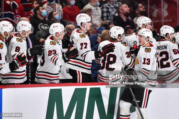 Henrik Borgstrom of the Chicago Blackhawks celebrates his goal with teammates on the bench during the third period against the Montreal Canadiens at...