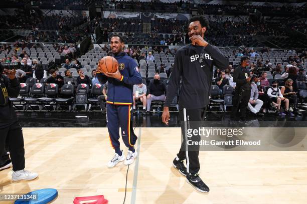 Monte Morris of the Denver Nuggets and Keita Bates-Diop of the San Antonio Spurs talk before a game on December 9, 2021 at the AT&T Center in San...