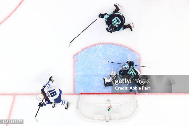 Philipp Grubauer of the Seattle Kraken gives up a goal to Kyle Connor of the Winnipeg Jets during the third period at Climate Pledge Arena on...