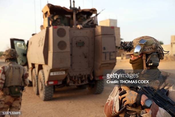 French soldiers patrol the streets of the village of Guintou near Gao on December 4, 2021. - France's anti-jihadist military force in the Sahel...