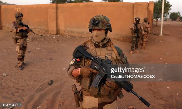 French soldiers patrol the streets of the village of Guintou near Gao on December 4, 2021. France's anti-jihadist military force in the Sahel region,...
